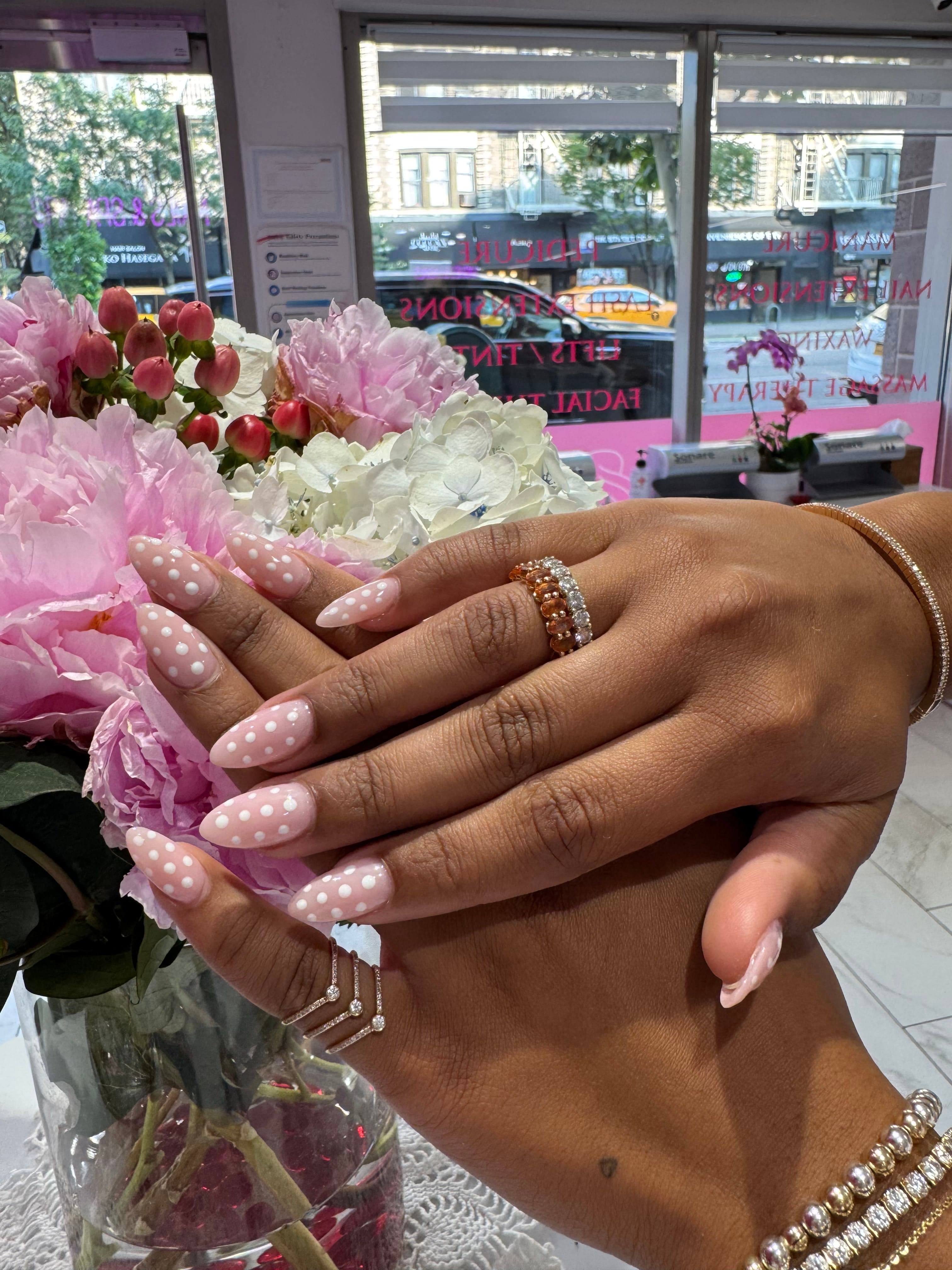 Blush nails with white polka dots