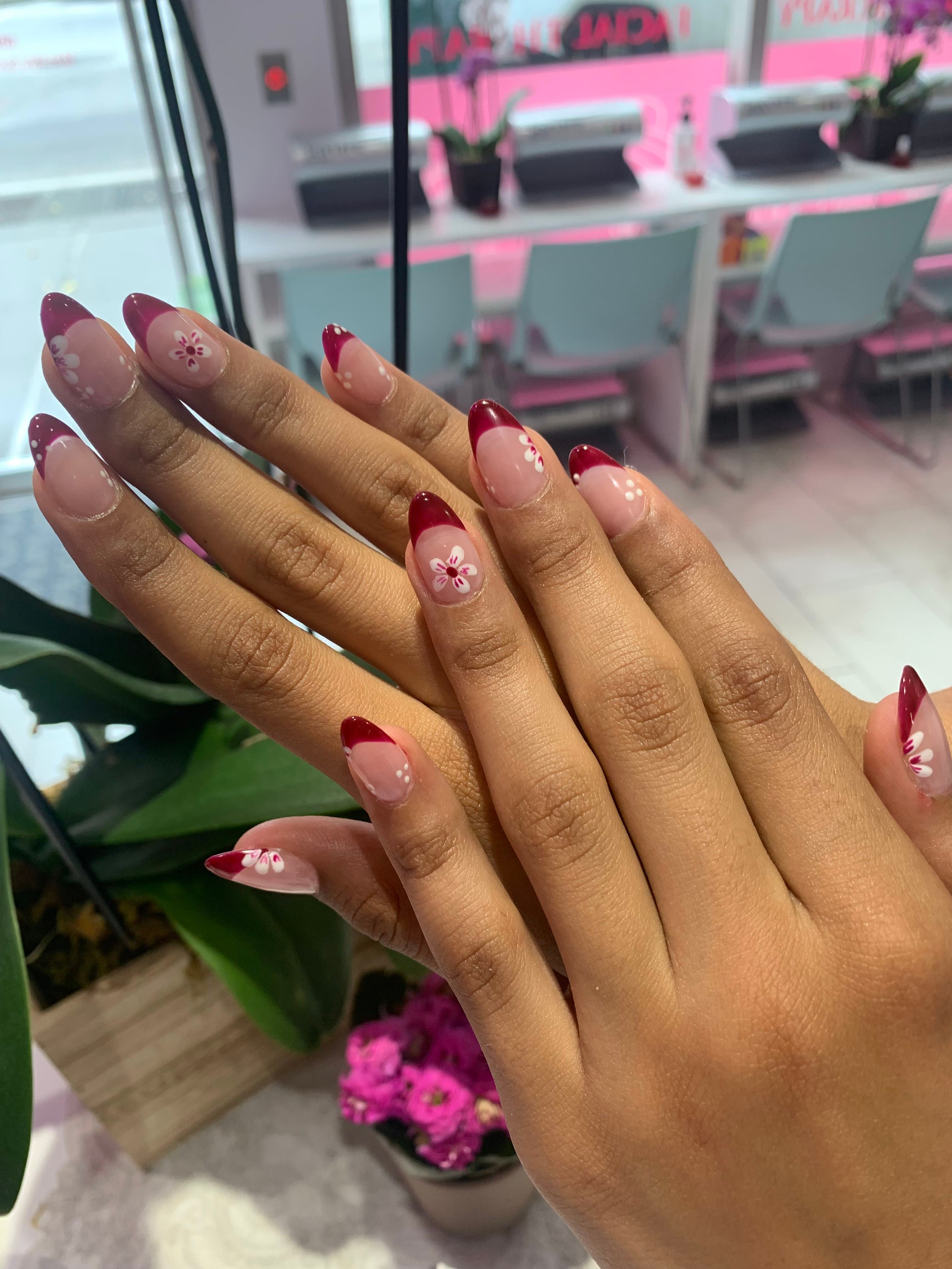Cherry-red French tips with white floral art