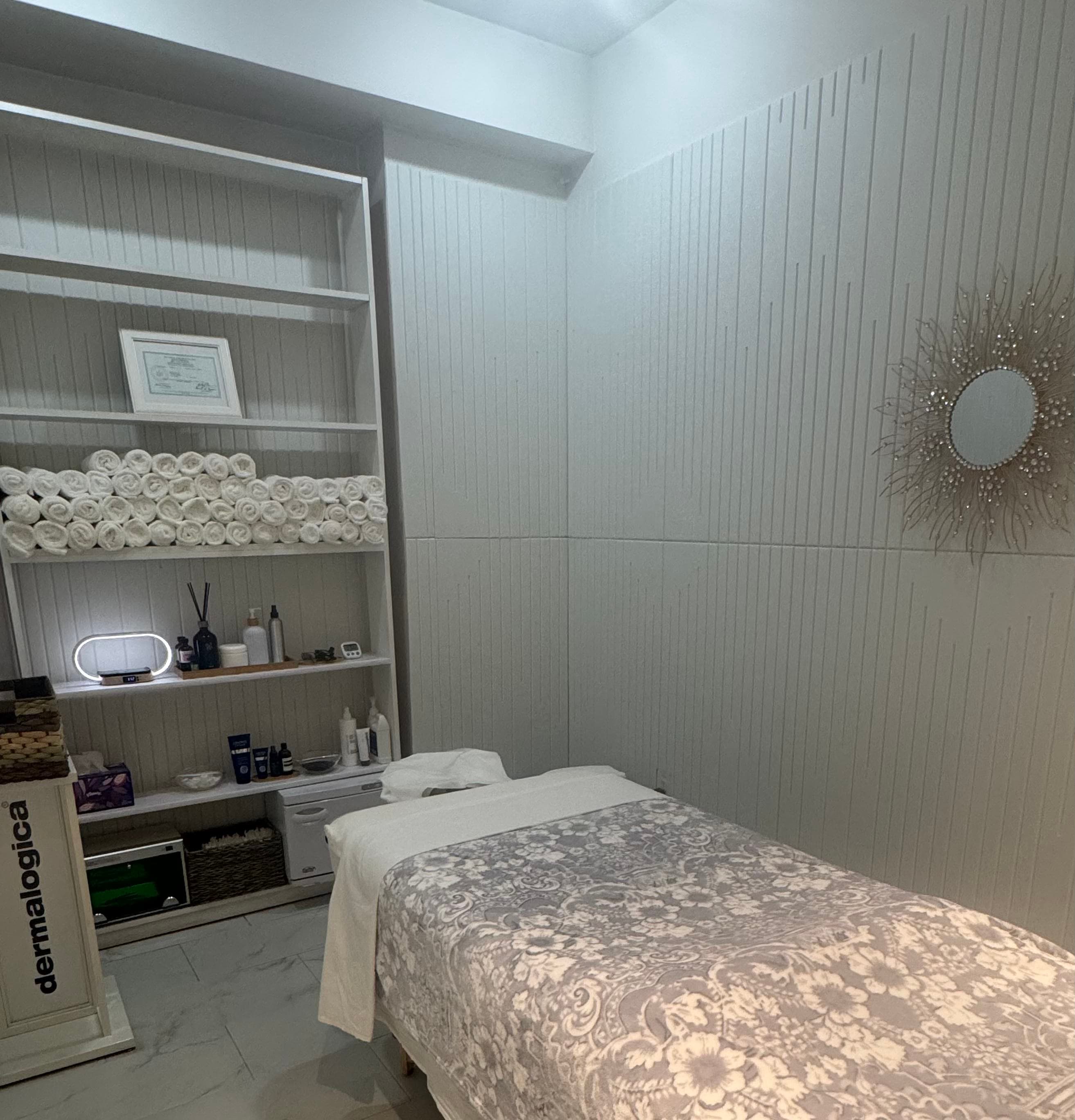 Calm facial treatment room with rolled towels