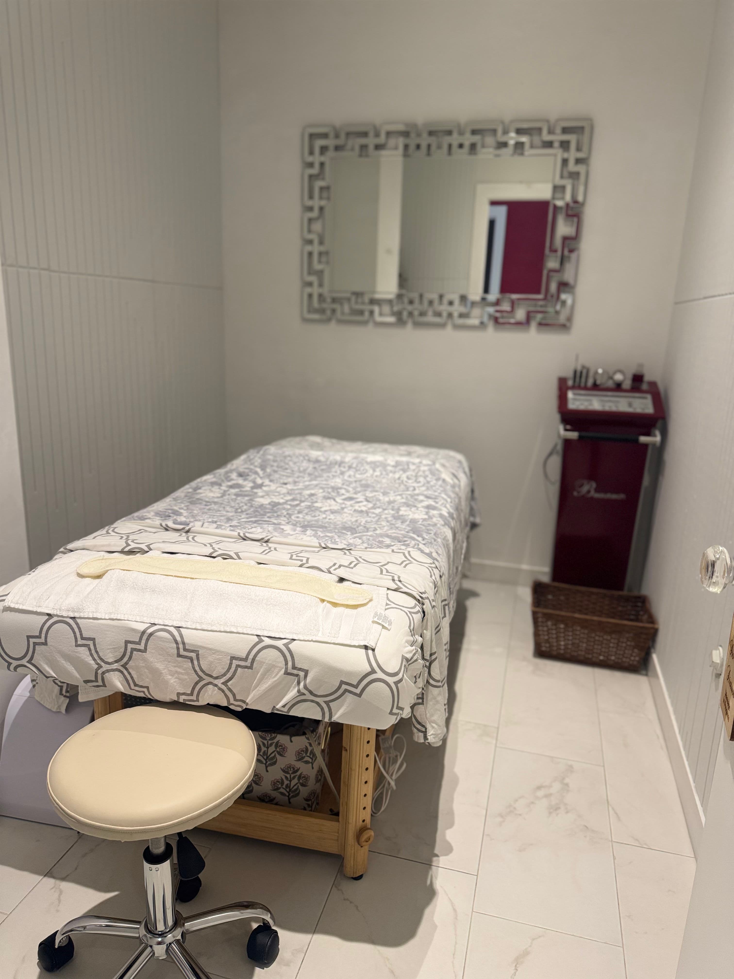 Private treatment room with facial bed
